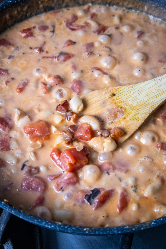 white cannellini beans and fire roasted tomatoes in a creamy broth