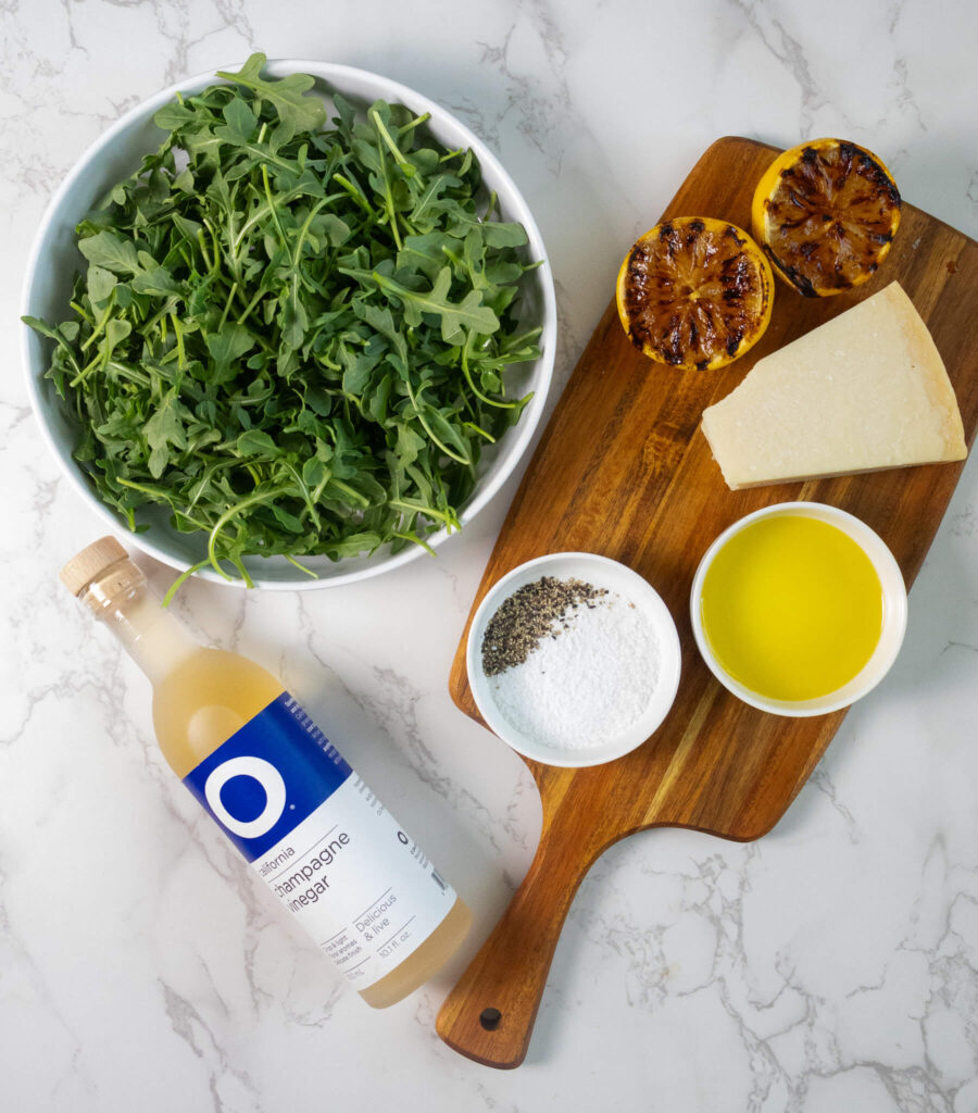 the ingredient spread for making parmesan and lemon arugula salad