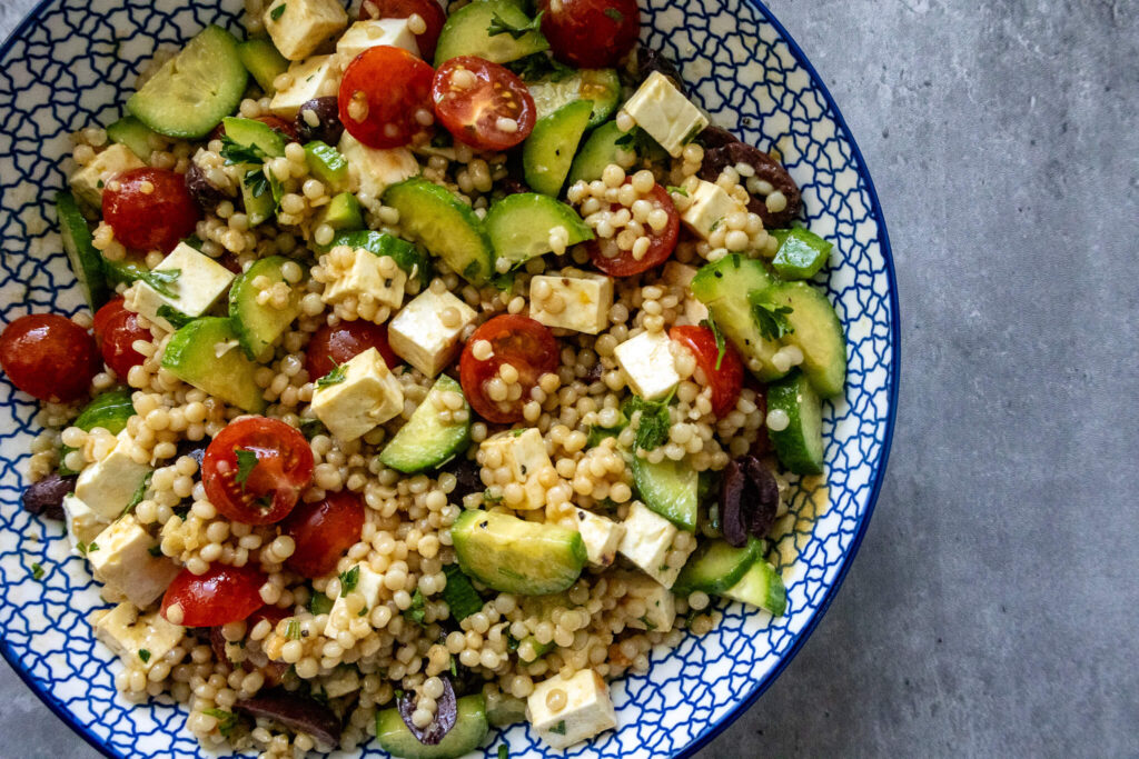 Mediterranean Couscous Salad with Red Wine Vinaigrette in a serving bowl