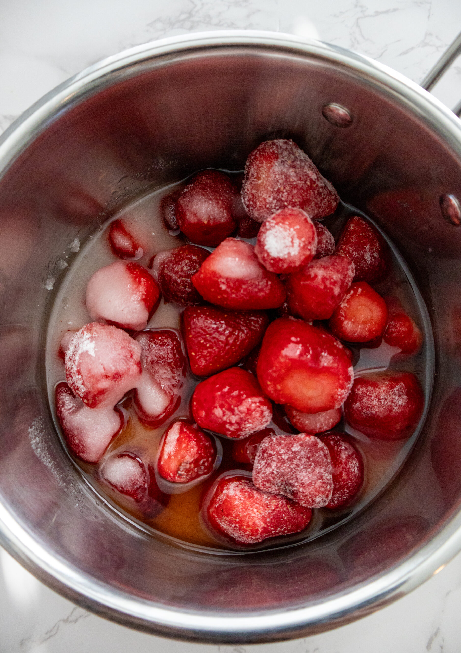 strawberries and syrup in a pan.